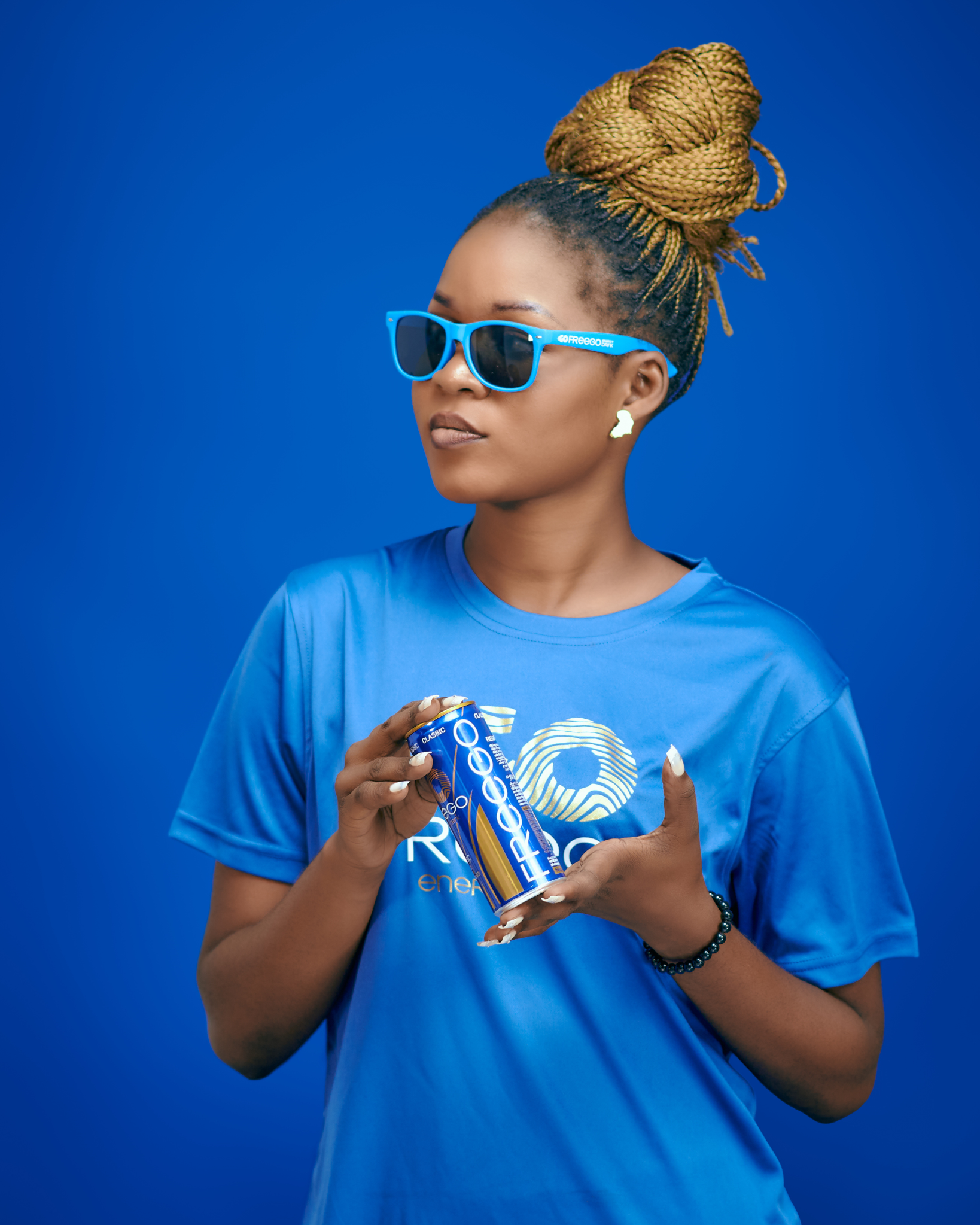 FREEGO brand ambassador holding a FREEGO can on a blue background